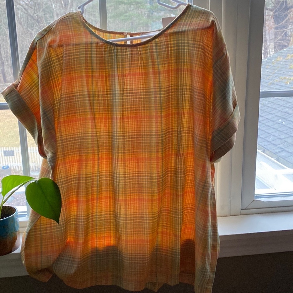 Soft yellow green and yellow plaid cotton/rayon blouse. Button closure at neck.